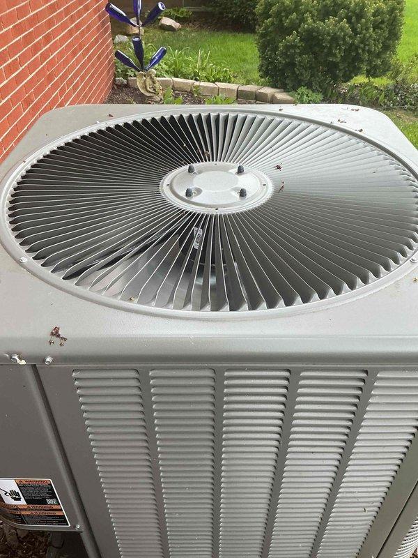 # Gold AC Inspection Completed

Performed comprehensive Gold-level preventive maintenance inspection on a one-year-old Lennox air conditioning condenser unit located in the backyard. Conducted thorough visual assessment of the exterior cabinet, confirming proper structural integrity with minimal weathering consistent with normal operation. Inspected the top-mounted fan assembly, including radial fan blades and central hub, verifying secure mounting and absence of physical damage or excessive wear.

Examined horizontal louvered ventilation panels on unit sides for unrestricted airflow and proper clearance from surrounding landscaping. Verified adequate clearance from brick wall and ground-level vegetation to maintain optimal air circulation around the condenser. Checked unit mounting stability on ground pad and confirmed level positioning.

Inspected electrical connections, refrigerant lines, and manufacturer labeling for proper documentation. Evaluated overall system condition, noting 