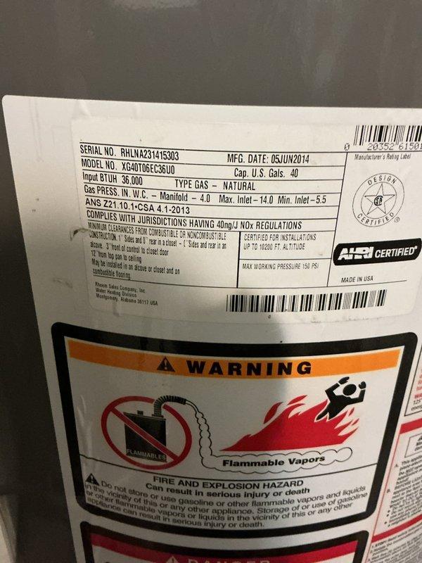 Responded to callback for furnace with no heat and error code in laundry room. Upon inspection, found natural gas furnace (Model XG40T06EC35U0, manufactured June 2014) still experiencing operational failure. Diagnosed system with blue flame present in combustion chamber, indicating ignition sequence initiating but heating cycle not completing. Verified refrigerant lines and service connections, documented equipment condition with illuminated evaporator coil visible through plenum access. Addressed recurring issue preventing heat production, cleared error code, and restored system to proper operation.