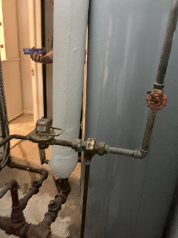 Responded to no heat call for one room in residence with 10+ year old steam boiler system located in basement. Performed diagnostic inspection of steam heating system and associated distribution piping. Examined boiler operation, steam supply lines, radiator connections, and air venting components serving affected zone. Inspected steam trap operation, checked for proper pitch on horizontal steam mains, and verified radiator valve functionality. Evaluated pressure controls, water level, and overall system operation. Identified issue preventing adequate steam delivery to single room radiator. Documented existing plumbing infrastructure including water heater installation, supply piping network with gate valves, and copper distribution lines showing normal aging patina. Explained findings to homeowner and provided recommendations for restoring proper heat distribution to affected area.