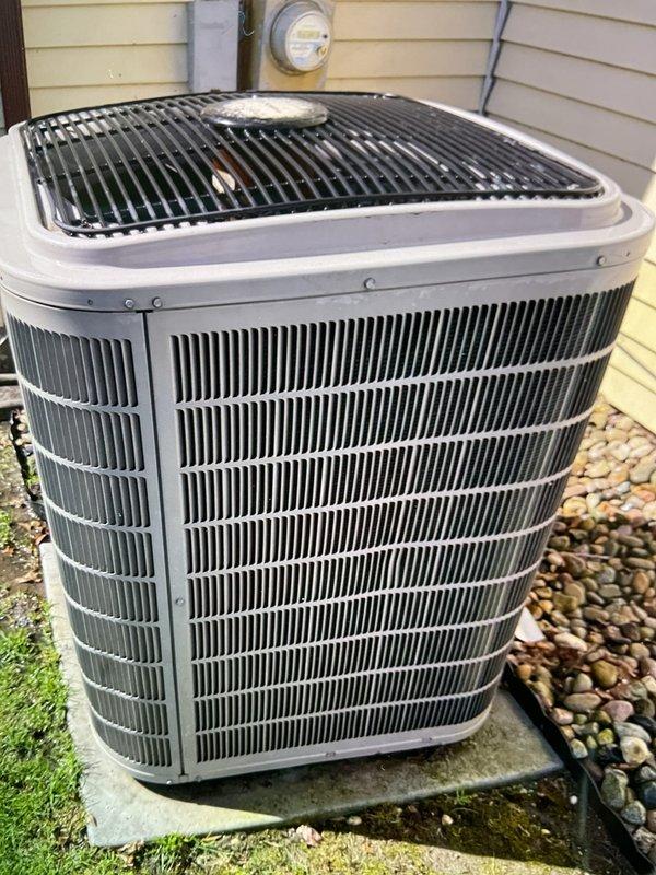 Completed comprehensive Gold AC inspection on 15-year-old residential air conditioning system with outdoor condenser unit and basement-located air handler. Performed thorough visual inspection of condenser unit exterior, noting minor damage to protective grille on top cover, examined electrical connections including contactor and capacitor, verified proper wiring connections with all color-coded cables secure at terminal points, and documented overall system condition through photographic evidence. System operational at time of inspection with all electrical components functioning within normal parameters.