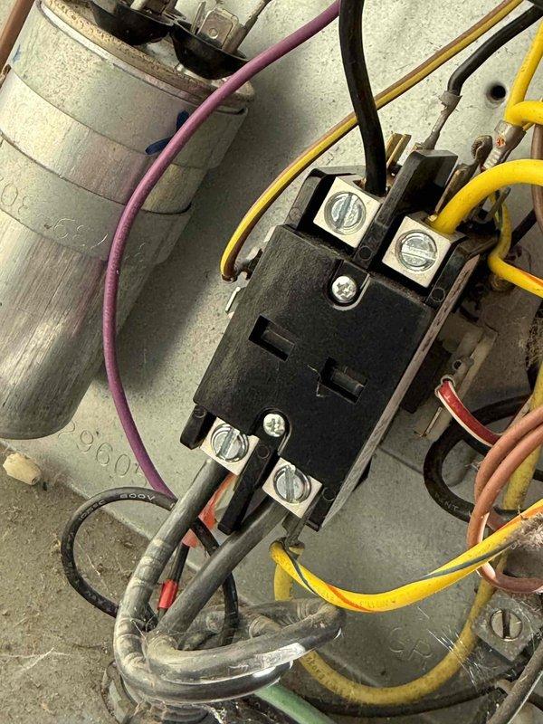 Completed comprehensive Gold AC inspection on 15-year-old residential air conditioning system with outdoor condenser unit and basement-located air handler. Performed thorough visual inspection of condenser unit exterior, noting minor damage to protective grille on top cover, examined electrical connections including contactor and capacitor, verified proper wiring connections with all color-coded cables secure at terminal points, and documented overall system condition through photographic evidence. System operational at time of inspection with all electrical components functioning within normal parameters.