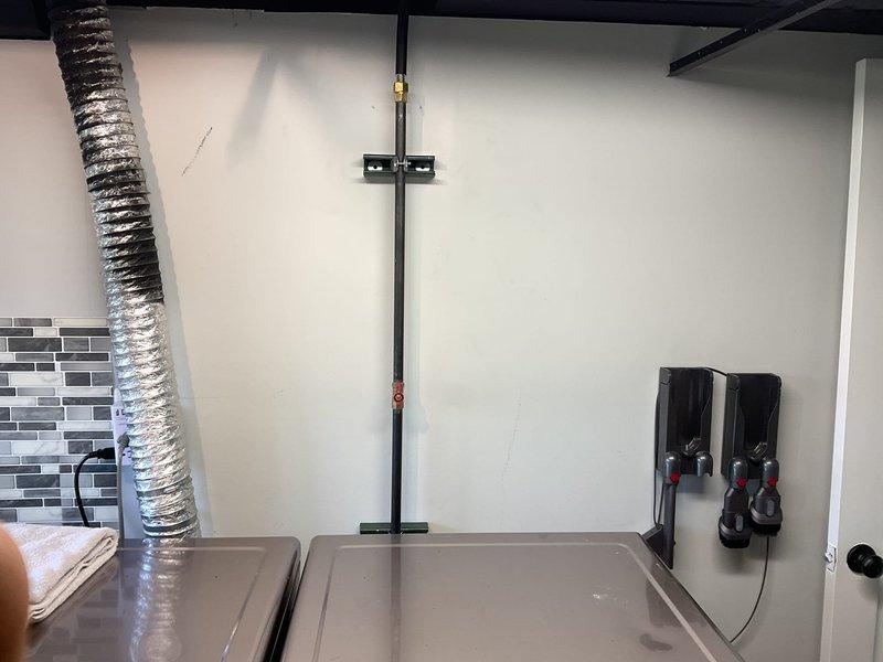 Completed commercial gas line installation in mechanical/utility space. Routed new gas piping through ceiling area, connecting to existing infrastructure with proper joints and fittings. Installed wall-mounted support bracket and secured gas line with appropriate mounting hardware per code requirements. All connections tested and tagged for identification. System ready for operation.