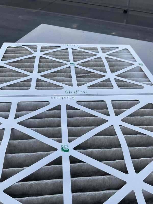 Completed spring maintenance on two commercial rooftop units as part of scheduled preventive maintenance agreement. Accessed RTU equipment via ladder, performed comprehensive system inspection including refrigerant lines, electrical connections, and operational controls. Replaced dirty GlasFloss air filters on both units to restore proper airflow and system efficiency. Verified all safety labels present, checked refrigerant line integrity, and confirmed units operating within normal parameters upon completion.