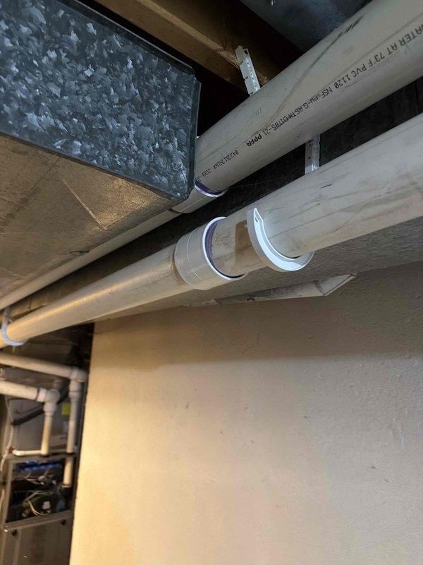 Responded to service call for 4-year-old furnace located in basement with exhaust pipe dripping issue. Upon inspection, identified condensate drainage problem in the PVC exhaust piping system. Replaced defective 3-inch coupling on the exhaust pipe assembly to eliminate moisture leakage. Secured all PVC piping with proper mounting brackets to ensure proper drainage slope and prevent future condensate backup. Verified furnace operation and confirmed exhaust system is functioning correctly with no further dripping or moisture issues.