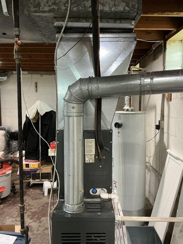 Completed full HVAC system replacement including removal of 18-year-old furnace with cracked heat exchanger and non-functional air conditioning equipment. Installed new high-efficiency furnace with properly configured ductwork connections and new condensing unit. Replaced existing 40-gallon water heater with new unit, ensuring proper venting and code-compliant installation. All systems tested and operational upon completion.