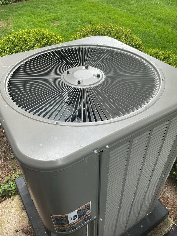 Completed comprehensive Gold AC Inspection on two residential air conditioning systems, both less than one year old and currently operational. Performed thorough visual examination of outdoor condenser units, verifying proper installation on concrete pads with adequate clearance and drainage. Inspected fan grilles, housing integrity, and external components for signs of damage, corrosion, or premature wear. Confirmed manufacturer labels and data plates are intact and legible. Evaluated ventilation louvers for unrestricted airflow and assessed overall unit condition. Air handler and coil system located in basement was included in multi-unit inspection protocol. All equipment found to be in good working order with no immediate service needs identified. Photographic documentation captured for maintenance records.