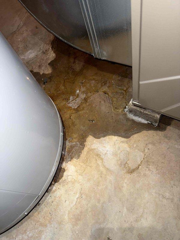 Completed comprehensive tune-up on 20-year-old air conditioning system with outdoor condenser unit and basement air handler. Performed standard maintenance protocol including refrigerant pressure check using manifold gauges, inspected electrical connections, cleaned condenser coils, and verified proper system operation. Identified water accumulation on basement floor near equipment, indicating potential condensate drain line issue or secondary drain pan overflow that will require monitoring or future service to prevent water damage.