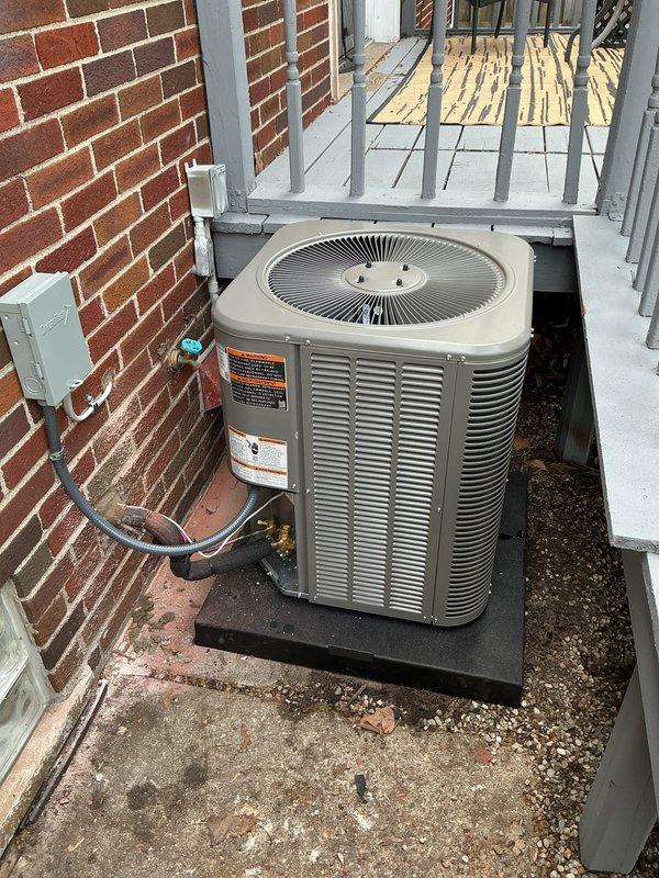 Completed full installation of 2-ton air conditioning system with matching evaporator coil. Unit positioned on rubber mounting pad in exterior service access area adjacent to building structure. Installed electrical disconnect box with proper conduit routing from wall to equipment. Configured PVC condensate drainage system with pump assembly to handle moisture removal. All mechanical, electrical, and air conditioning permits obtained and work performed to code. Humidifier reconnected to system. System tested and operational.