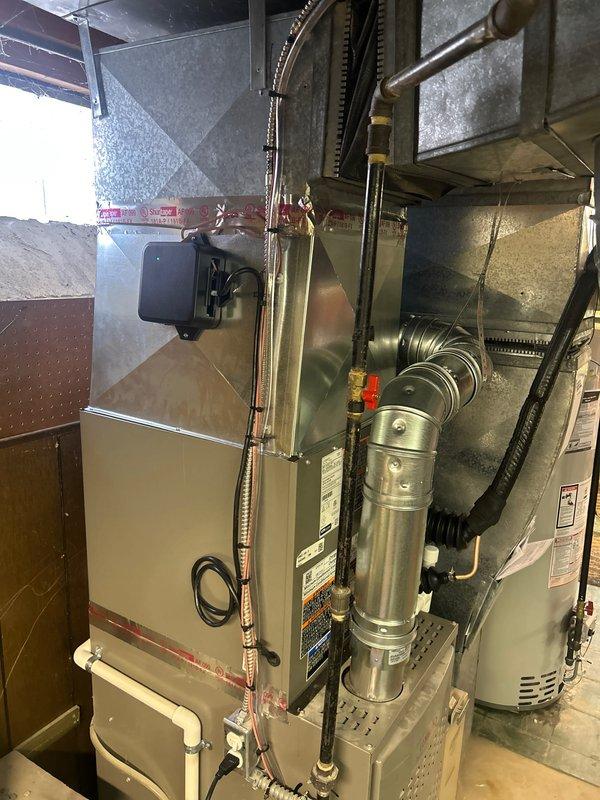 Completed installation of 2-ton air conditioning system with matching evaporator coil in rear yard location. Installed new 50-gallon hot water heater with condensate pump and liner in basement mechanical room. Added Ecobee 3 Lite smart thermostat with new wiring run. Performed system evacuation and refrigerant charge, verified pressures reading 10.14 psig low side and 182.5 psig high side with proper subcooling and superheat values. Completed line flush and system startup. All mechanical, electrical, and plumbing permits requested and approved. Unit reconnected to existing ductwork with proper refrigerant line installation and insulation. System tested and operational, qualified for utility rebate program.