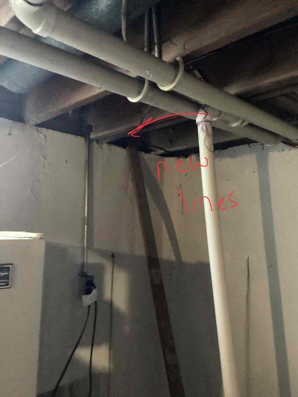 Completed air conditioning tune-up on a 20-year-old AC unit located in the basement. Performed standard maintenance procedures including system inspection, cleaning, and performance verification of the cooling system. The HVAC installation includes a gray metal furnace with mounted Honeywell humidifier, associated ductwork with reflective insulation, and a water heater in the mechanical room area.
