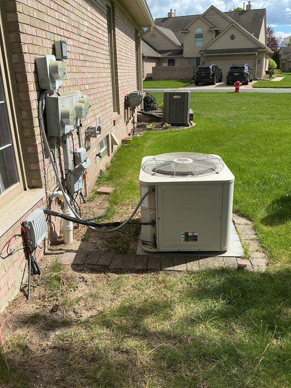 Conducted on-site evaluation for air conditioning replacement at a 3-bedroom residential condo with multi-level configuration. Assessed existing outdoor condenser unit located on concrete pad in side yard with refrigerant lines and electrical connections running to interior system. Evaluated basement mechanical infrastructure including PVC plumbing and ductwork to determine compatibility with new equipment installation. Provided replacement estimate options for Carrier and Lennox systems based on performance requirements and available manufacturer rebate programs, with consideration for veteran discount eligibility.