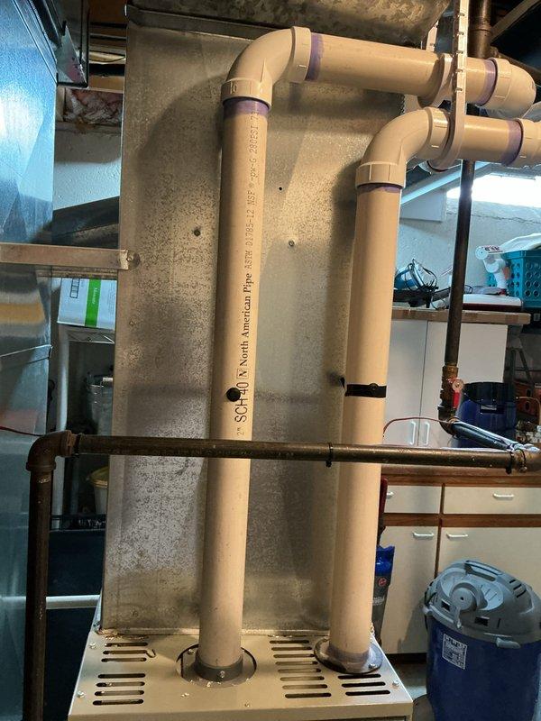 Conducted on-site evaluation for air conditioning replacement at a 3-bedroom residential condo with multi-level configuration. Assessed existing outdoor condenser unit located on concrete pad in side yard with refrigerant lines and electrical connections running to interior system. Evaluated basement mechanical infrastructure including PVC plumbing and ductwork to determine compatibility with new equipment installation. Provided replacement estimate options for Carrier and Lennox systems based on performance requirements and available manufacturer rebate programs, with consideration for veteran discount eligibility.