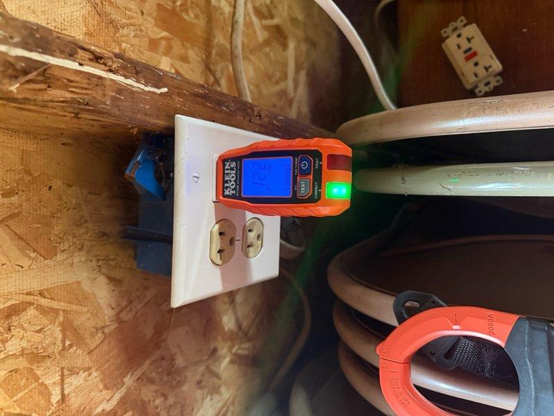 Responded to service call for no power in garage. Upon arrival, performed electrical diagnostics using digital multimeter to test outlet functionality and circuit integrity. Testing revealed power supply issues at garage receptacle mounted on wooden framing in utility space. Verified proper voltage readings and circuit continuity after troubleshooting. Utilized Klein Tools testing equipment to confirm restoration of electrical service to affected outlets. All receptacles tested and verified operational upon completion.
