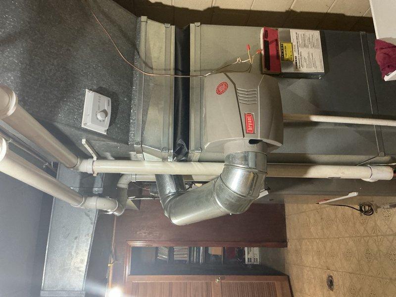Responded to service call for 14-year-old furnace in basement producing clicking noise during operation. Performed diagnostic inspection of air handler unit, ductwork connections, electrical components, and control systems. Upon examination, identified potential issues with blower assembly or gas valve operation causing the audible clicking sound. Inspected electrical transformer box, wiring connections, condensate drainage system, and thermostat control to ensure proper system function and rule out secondary concerns.