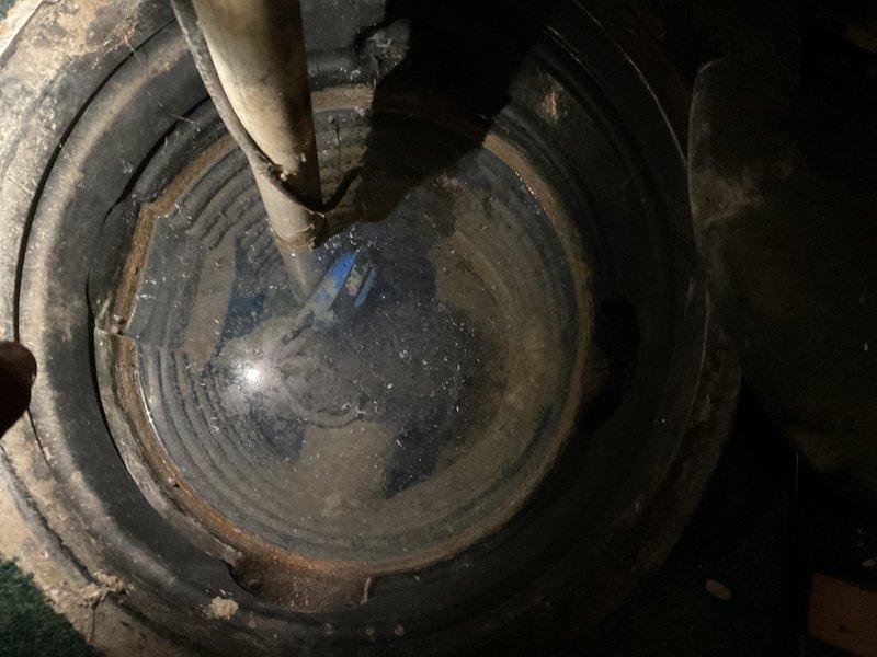 Responded to service call for non-functioning sump pump with reported electrical and float switch issues. Upon arrival, performed comprehensive diagnostic inspection of sump pump system located in basement pit. Verified power supply to pump unit and tested electrical connections at outlet and pump cord. Inspected submersible pump assembly with teal housing and discharge piping system. Evaluated float switch mechanism for proper operation and freedom of movement, noting significant sediment buildup and debris accumulation within the sump basin affecting float functionality. Cleaned float assembly and verified unrestricted vertical travel range. Tested pump motor operation and confirmed proper cycling when float was manually activated. Examined discharge line for obstructions and verified proper water flow through gray PVC piping. Assessed overall condition of pump basin, noting mineral deposits and moisture accumulation on interior walls consistent with regular water exposure. Confirmed