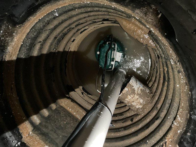 Responded to service call for non-functioning sump pump with reported electrical and float switch issues. Upon arrival, performed comprehensive diagnostic inspection of sump pump system located in basement pit. Verified power supply to pump unit and tested electrical connections at outlet and pump cord. Inspected submersible pump assembly with teal housing and discharge piping system. Evaluated float switch mechanism for proper operation and freedom of movement, noting significant sediment buildup and debris accumulation within the sump basin affecting float functionality. Cleaned float assembly and verified unrestricted vertical travel range. Tested pump motor operation and confirmed proper cycling when float was manually activated. Examined discharge line for obstructions and verified proper water flow through gray PVC piping. Assessed overall condition of pump basin, noting mineral deposits and moisture accumulation on interior walls consistent with regular water exposure. Confirmed