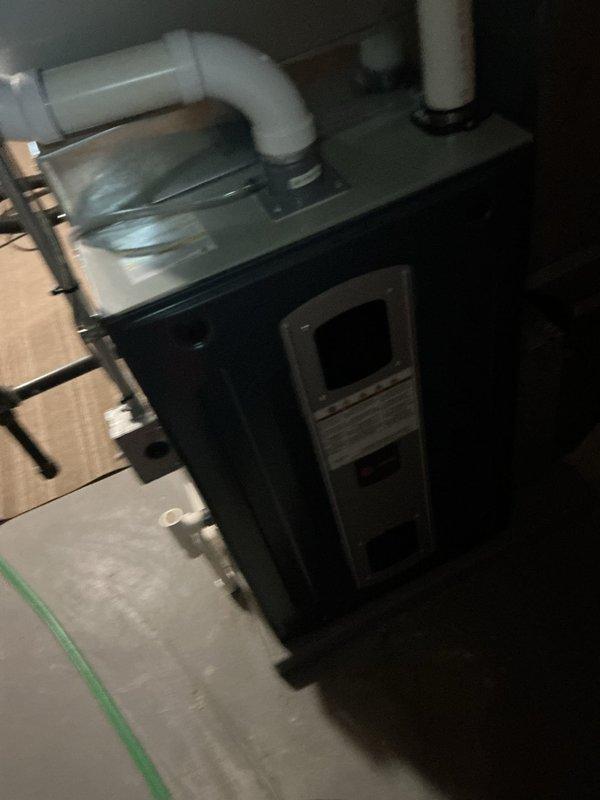 Completed Gold AC Inspection on 10-year-old system with evaporator coil located in basement. Performed comprehensive maintenance including visual inspection of furnace unit, verified proper condensate drain operation through white PVC piping system, and documented equipment condition through photographic records. Unit operating within normal parameters with no immediate service needs identified at time of inspection.