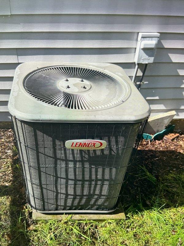 Completed Gold AC Inspection on 16-year-old Lennox air conditioning system with outdoor condenser unit and first floor closet air handler. Performed comprehensive system evaluation including visual inspection of condenser unit, which showed dirt accumulation on top panel and surrounding area requiring debris clearance. Evaporator coil inspection revealed heavy soiling with significant dust, dirt, and debris buildup throughout finned surfaces, along with cobweb accumulation affecting airflow efficiency. Documented equipment condition through photographic evidence showing condenser unit positioning on grade with proper clearances and electrical disconnect box mounting. Advised customer on necessary maintenance recommendations including condenser area clearance from debris and animal waste, and noted evaporator coil cleaning requirements to restore optimal system performance and efficiency.