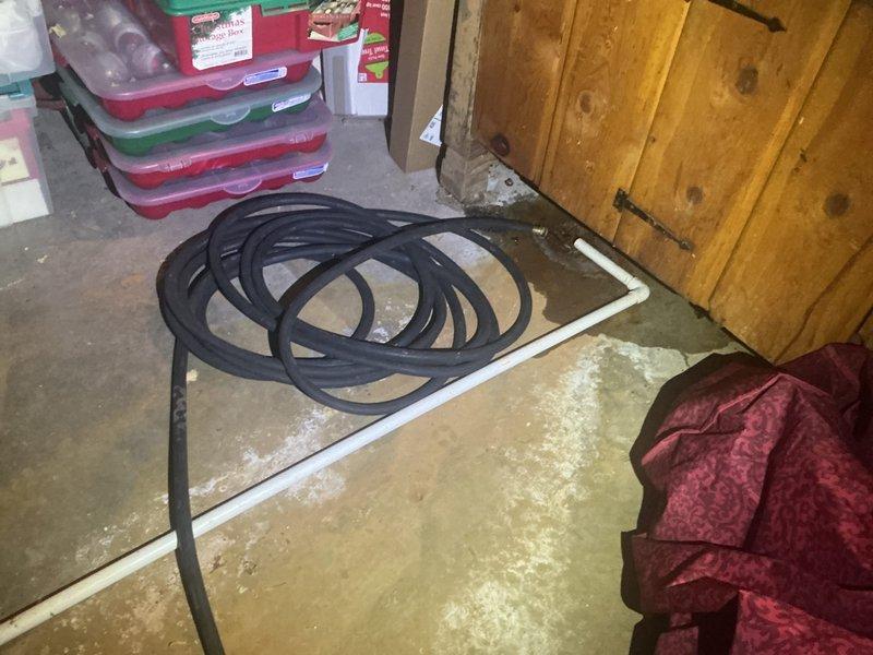 Responded to complaint of sulfur odor emanating from two tanked water heaters in residential property. Inspected both units and confirmed hydrogen sulfide smell commonly associated with bacterial reaction with magnesium or aluminum anode rods. Observed evidence of water leakage and moisture damage on basement concrete floor near equipment area. Documented existing conditions including water staining and HVAC equipment proximity. Recommended anode rod replacement with powered anode or zinc-aluminum alloy rods to eliminate sulfur bacteria growth and odor issue in both water heating systems.