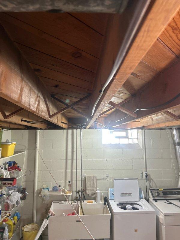 Completed installation of 2-ton air conditioning system with evaporator coil in basement utility area. Installed new condensate pump with proper drainage connections, reconnected all refrigerant lines and electrical components, and verified thermostat operation. System tested and confirmed operational with proper airflow and cooling performance.