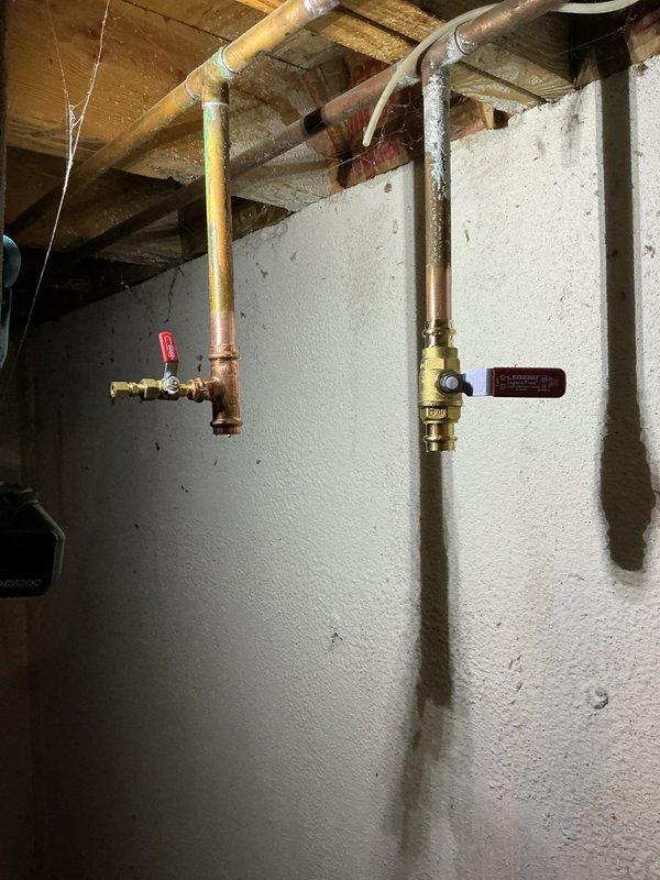 Completed installation of a 50-gallon short Bradford White tanked water heater in basement utility area. Reconnected all copper supply lines, installed brass shut-off valves with proper venting configuration, and verified system operation with no leaks detected.