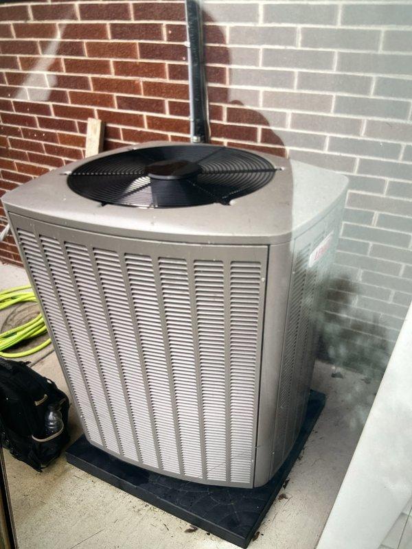 Completed comprehensive Gold AC inspection on residential split system less than one year old with air handler located in attic. Performed visual inspection of outdoor condensing unit, which showed proper installation on rubber isolation pad with adequate clearance and ventilation. Connected refrigerant diagnostics equipment and recorded system pressures and temperatures for R454B refrigerant: suction pressure 106.5 psi with vapor saturation temperature of 39.8°F, liquid line pressure 250.8 psi with liquid saturation temperature of 87.6°F. Measured suction line temperature at 62.3°F and liquid line temperature at 80.6°F, calculating superheat at 22.5°F and subcooling at 7.0°F, both within acceptable operating parameters for proper system performance.