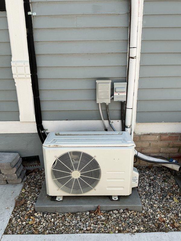 Completed estimate for replacement of 10+ year old ductless mini-split system. Assessed existing wall-mounted indoor air handler unit installed in living space and outdoor condenser unit positioned on concrete pad with gravel base. Provided replacement options and recommendations based on current system age and configuration.