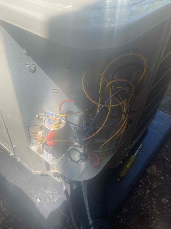 Completed AC tune-up on 6-year-old Bryant condenser unit with basement coil system. Performed visual inspection of outdoor condenser unit, removed access panel to inspect internal electrical components including capacitor and wiring connections, and verified all components were secure and functioning properly. Unit found in good operational condition with no immediate repairs needed.