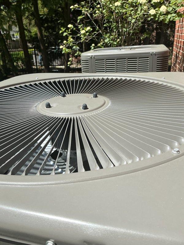 Completed comprehensive Gold AC inspection on 2-year-old residential HVAC system with air handler located in basement. Performed thorough evaluation of outdoor condenser units, verifying proper operation of fan motors, compressor function, and airflow through coil fins. Inspected condenser fan blades and grilles, confirming clean condition with no debris accumulation or obstructions. Evaluated electrical connections, refrigerant levels, and overall system performance under optimal weather conditions. Verified equipment is operating efficiently with no visible signs of wear, damage, or deterioration. Advised customer to maintain clear area around condenser units, keeping debris and animal waste away from equipment to ensure proper airflow and system longevity.