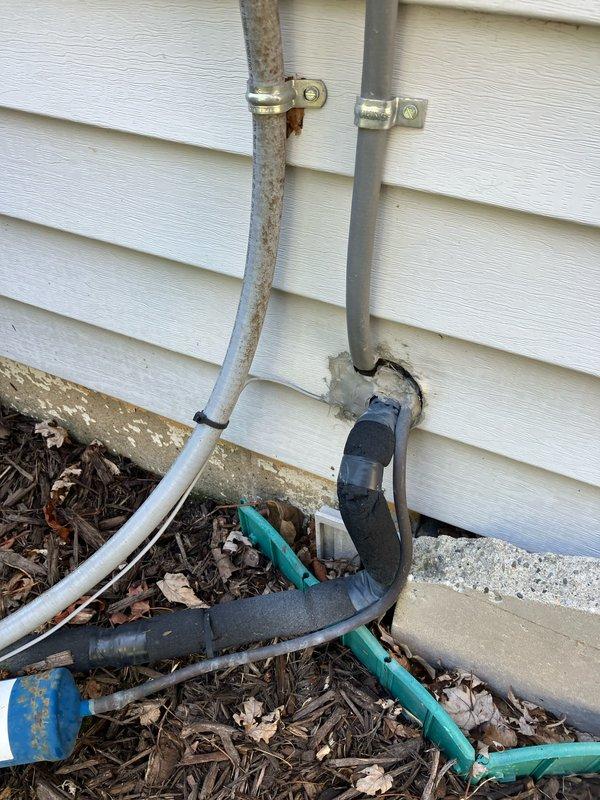 Completed full system replacement estimate for 16-year-old HVAC equipment with air handler/coil located in first floor closet. Documented existing system conditions including severely corroded refrigerant lines on exterior with significant rust deterioration, multiple utility penetrations through building envelope with accumulated debris at foundation level, and electrical service routing along exterior wall. Advised property owner that condenser area must be cleared of debris and animal waste prior to installation, and confirmed inspection scheduling is weather-dependent with minimum 65-degree temperature requirement for accurate equipment evaluation.