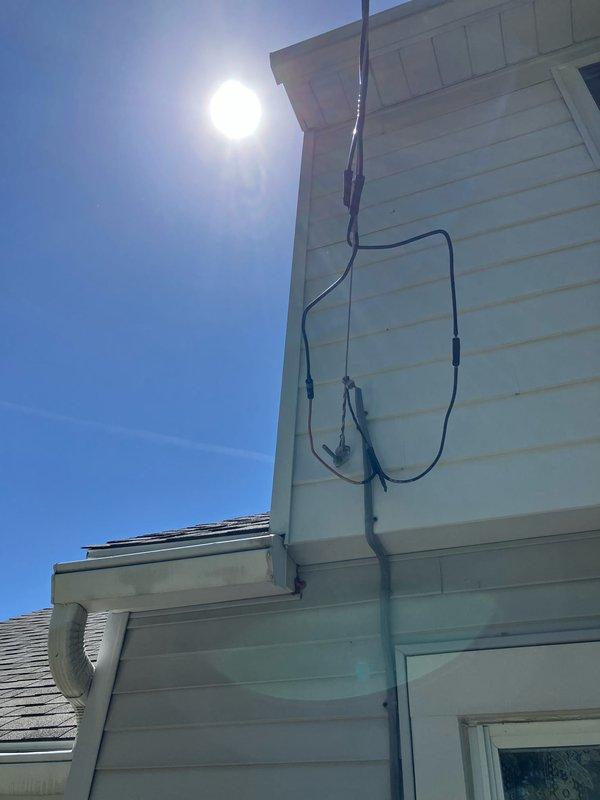 Completed full system replacement estimate for 16-year-old HVAC equipment with air handler/coil located in first floor closet. Documented existing system conditions including severely corroded refrigerant lines on exterior with significant rust deterioration, multiple utility penetrations through building envelope with accumulated debris at foundation level, and electrical service routing along exterior wall. Advised property owner that condenser area must be cleared of debris and animal waste prior to installation, and confirmed inspection scheduling is weather-dependent with minimum 65-degree temperature requirement for accurate equipment evaluation.