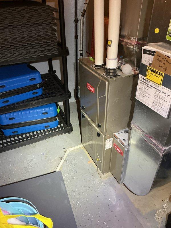Completed comprehensive Gold AC inspection on 10+ year old Bryant HVAC system with air handler located in basement. Performed thorough evaluation of furnace unit, air handler components, and thermostat operation, verifying system functionality with current heating settings at 70°F and ambient temperature reading of 74°F. All equipment inspected and photographed for service records.