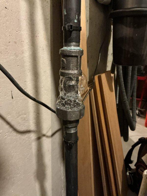 Responded to service call for reported gas odor near 1-year-old furnace located in basement. Upon inspection, identified issue with Noritz tankless water heater exhaust venting system rather than furnace. Performed diagnostic evaluation using combustion analyzer to assess flue gas conditions and verify proper venting. Determined that exhaust vent configuration required modification to meet manufacturer specifications and ensure safe operation. Documented current installation with photos showing existing PVC vent piping and water heater mounting. Identified necessary materials including 3" PVC pipe, fittings, and couplings required to complete vent reconfiguration. Unit is currently operational but requires vent system modifications to address concerns and ensure code compliance.