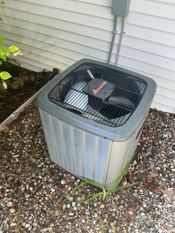 Completed annual cooling maintenance on a 4-year-old residential air conditioning system. System was operational upon arrival and customer reported no current issues. Performed comprehensive AC tune-up including inspection of outdoor condenser unit, verification of electrical connections and conduit, assessment of cabinet condition and fan assembly operation, and evaluation of unit placement and surrounding clearances. Cleared minor vegetation and debris from gravel pad area around condenser to ensure proper airflow. Confirmed protective top grille secure and all ventilation openings unobstructed. System tested and found to be functioning properly with no deficiencies noted. Unit left in good operating condition.