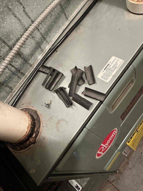 Responded to no heat call on 22-year-old Rheem furnace in basement. Upon inspection, found inducer motor failed with significant deterioration and corrosion of motor housing and components. Blower fan was operational but unit unable to establish proper draft due to failed inducer assembly. Extensive mineral deposits and white residue observed throughout inducer housing, indicating long-term moisture exposure and end-of-service-life failure. Diagnosed complete inducer motor replacement required. Ordered replacement inducer motor from supply house under purchase order for installation.