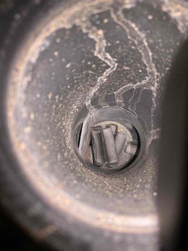 Responded to no heat call on 22-year-old Rheem furnace in basement. Upon inspection, found inducer motor failed with significant deterioration and corrosion of motor housing and components. Blower fan was operational but unit unable to establish proper draft due to failed inducer assembly. Extensive mineral deposits and white residue observed throughout inducer housing, indicating long-term moisture exposure and end-of-service-life failure. Diagnosed complete inducer motor replacement required. Ordered replacement inducer motor from supply house under purchase order for installation.