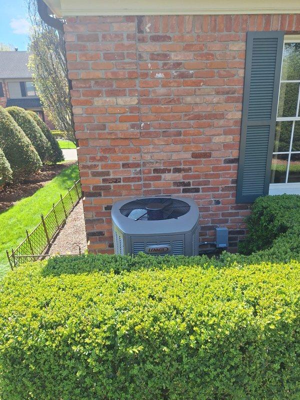 Completed installation of a 4-ton Lennox air conditioning system with matching evaporator coil at rear of residence. Unit was positioned on concrete pad against brick exterior wall with proper clearances maintained for service access and airflow. All mechanical and electrical connections were completed per manufacturer specifications and local code requirements, with permits requested for mechanical and electrical work. System was tested, charged, and verified operational upon completion.