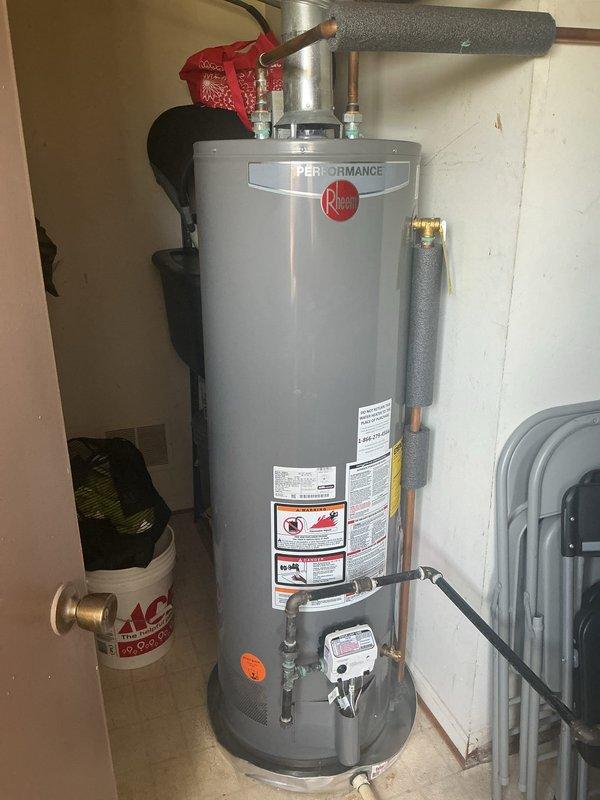 Completed comprehensive 16-point plumbing inspection on two residential units within the same condominium complex. Inspected Performance brand gas water heater installation, verifying proper pipe insulation, gas control valve operation, temperature/pressure relief valve functionality, and all safety components. Examined under-sink plumbing systems including P-trap assemblies, chrome tailpieces, flexible braided supply lines, and drain connections to ensure proper installation and absence of leaks.