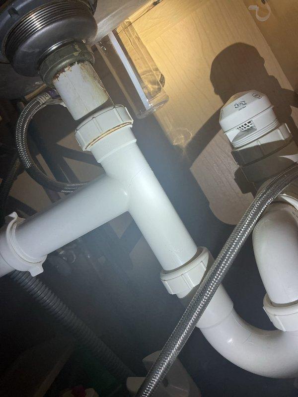 Completed comprehensive 16-point plumbing inspection on two residential units within the same condominium complex. Inspected Performance brand gas water heater installation, verifying proper pipe insulation, gas control valve operation, temperature/pressure relief valve functionality, and all safety components. Examined under-sink plumbing systems including P-trap assemblies, chrome tailpieces, flexible braided supply lines, and drain connections to ensure proper installation and absence of leaks.