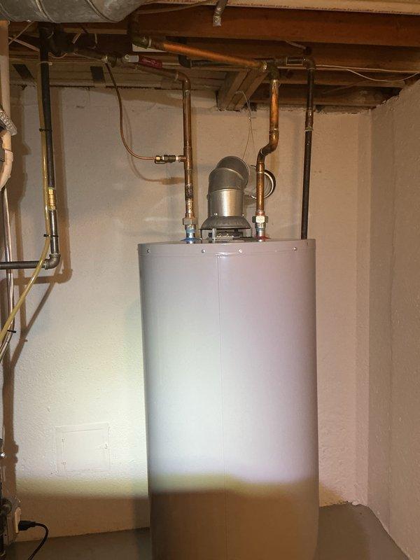 Completed comprehensive Gold AC Inspection on residential HVAC system with air handler/coil unit located in basement. Equipment is under 10 years old and in serviceable condition. Performed standard inspection protocol including visual assessment of all accessible components, connections, and surrounding mechanical systems. Documented condition of ductwork, piping connections, and utility infrastructure in basement area. Observed refrigerant line connections and insulation at junction points. Advised customer that outdoor condenser area must be kept clear of debris and animal waste for optimal system performance and to prevent future maintenance issues. Verified all accessible plumbing and mechanical connections associated with HVAC system installation. Captured photographic documentation of equipment condition and installation for service records.