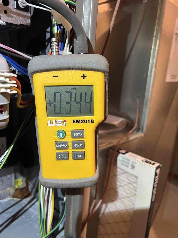 Completed routine maintenance and tune-up on two 10-year-old air conditioning units located at rear of property. Performed comprehensive inspection of both outdoor condenser units, verified proper airflow through louvered panels and fan operation, measured system pressures using digital manometer showing +0.344 In-Wc reading at air handler, and inspected electrical connections and components. Both systems operating within normal parameters following maintenance procedures.