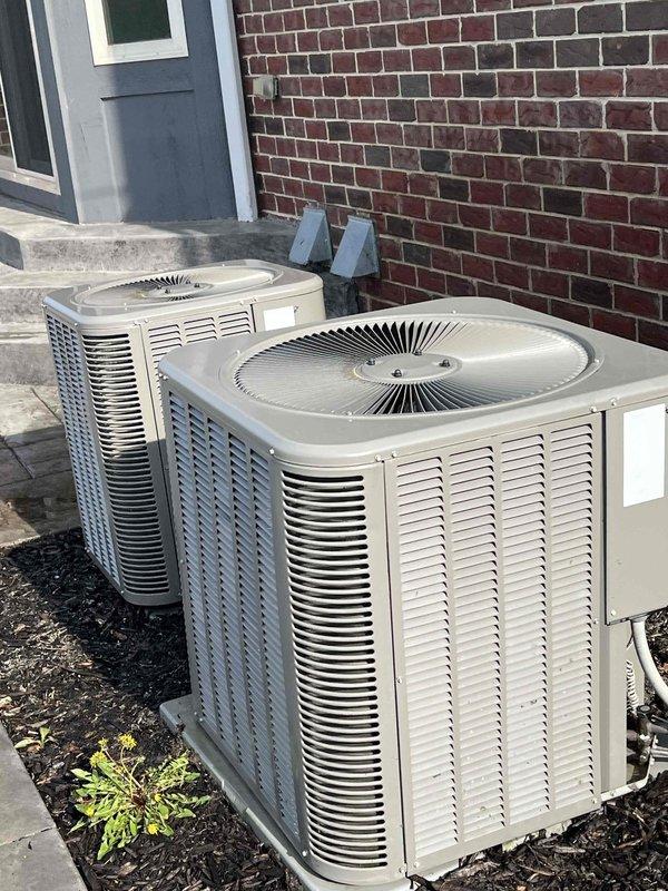 Completed routine maintenance and tune-up on two 10-year-old air conditioning units located at rear of property. Performed comprehensive inspection of both outdoor condenser units, verified proper airflow through louvered panels and fan operation, measured system pressures using digital manometer showing +0.344 In-Wc reading at air handler, and inspected electrical connections and components. Both systems operating within normal parameters following maintenance procedures.
