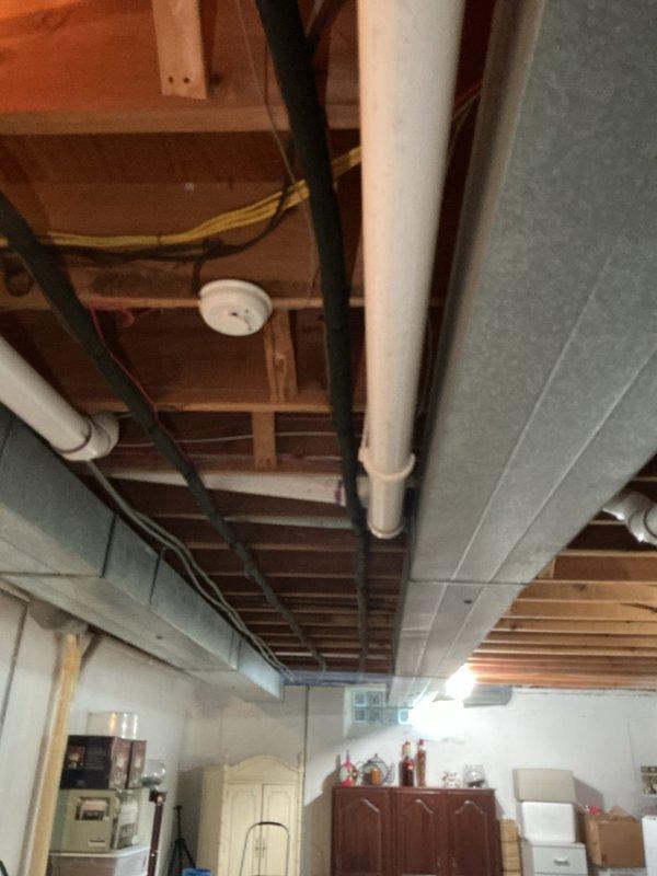 Completed estimate for replacement of two residential air conditioning units, both approximately 20 years old, located in basement. Units were evaluated following discovery of blown fuse during scheduled maintenance visit. Due to age of equipment and homeowner's preference to avoid further repair investments, full system replacement was recommended for both AC units. Assessment included inspection of existing ductwork, condensate drainage systems, and electrical connections visible in basement utility area.