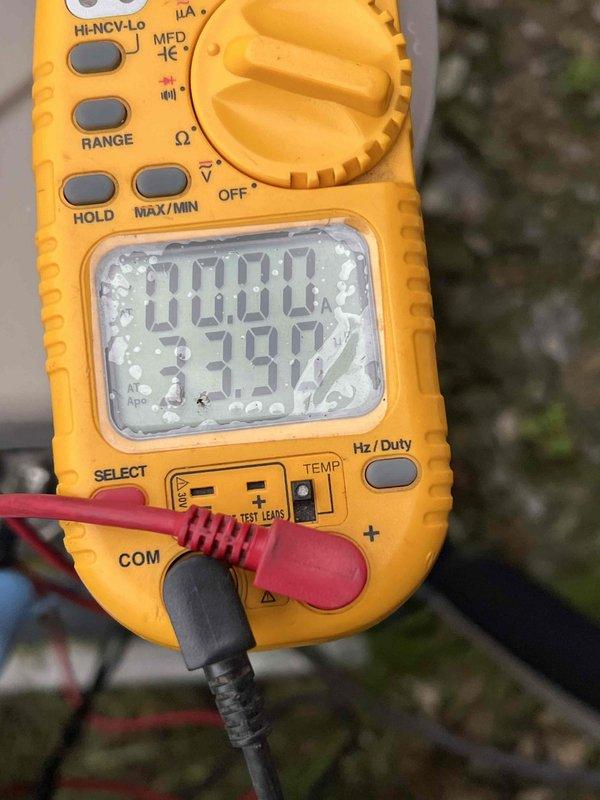 Completed Gold AC Inspection on 13-year-old air conditioning system with basement-located air handler. Performed comprehensive electrical diagnostics using digital multimeter, measuring voltage and capacitance readings to verify proper system operation. All electrical components tested within normal operating parameters, with voltage reading of 379.9V and secondary measurement of 1007, confirming system is functioning correctly and ready for cooling season.