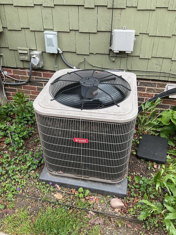 Completed preventive maintenance tune-up on 7-year-old Unico high-velocity air conditioning system with air handler located in attic. Performed comprehensive inspection of Bryant condensing unit, verified electrical connections at disconnect boxes, and measured operating amperage at 24.30A using clamp meter to confirm unit operating within manufacturer specifications. Homeowner reported one radiator not heating properly; system otherwise operational at time of service.