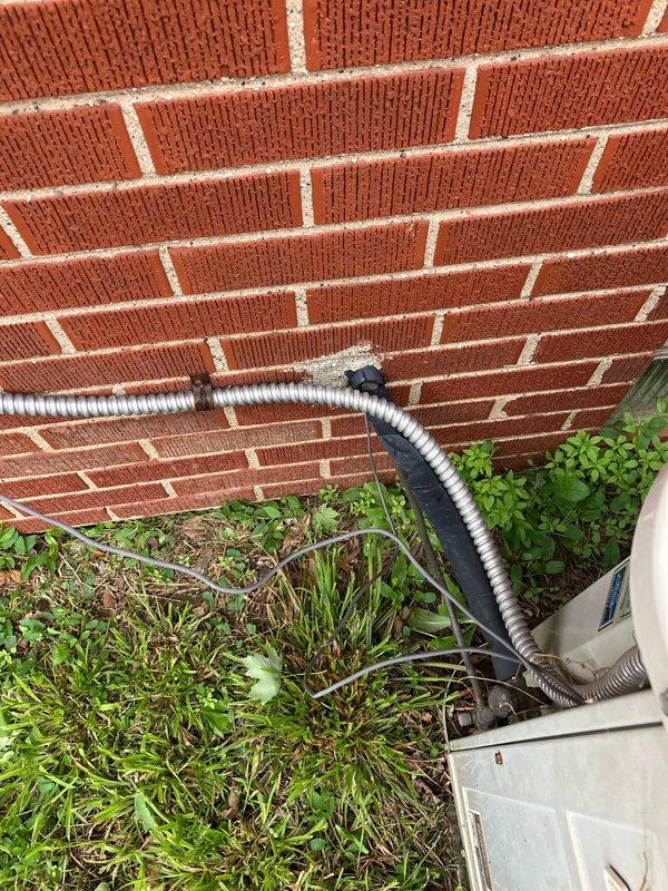 Responded to service call for 17-year-old furnace system not heating and blowing cold air. Upon inspection, diagnosed failed heat exchanger and defective gas valve in basement-located unit. Provided comprehensive estimate for complete HVAC system replacement including new furnace and outdoor condensing unit. Documented existing equipment condition showing weathered outdoor unit on concrete pad against building foundation with proper electrical disconnect and conduit installation. Customer advised of safety concerns with failed heat exchanger and recommended full system replacement due to age and extent of required repairs.