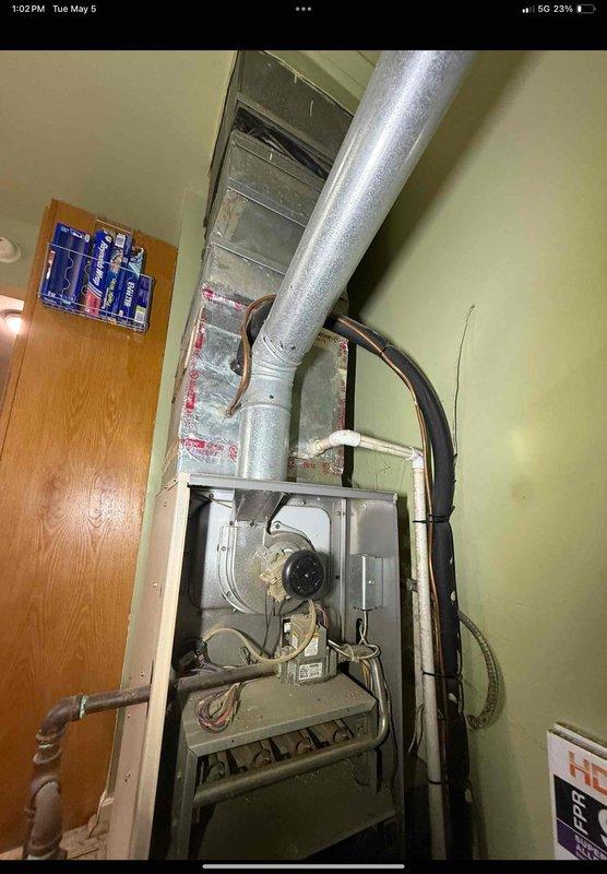 Performed comprehensive furnace tune-up and inspection addressing air circulation and heating concerns. Upon examination, discovered severely iced evaporator coils indicating restricted airflow or refrigerant issues. Opened furnace access panel to inspect blower motor, gas burner assembly, and internal components. Assessed ductwork connections and flexible duct routing for proper airflow. Documented ice accumulation on heat exchanger fins requiring immediate attention to restore proper system operation and prevent further damage.