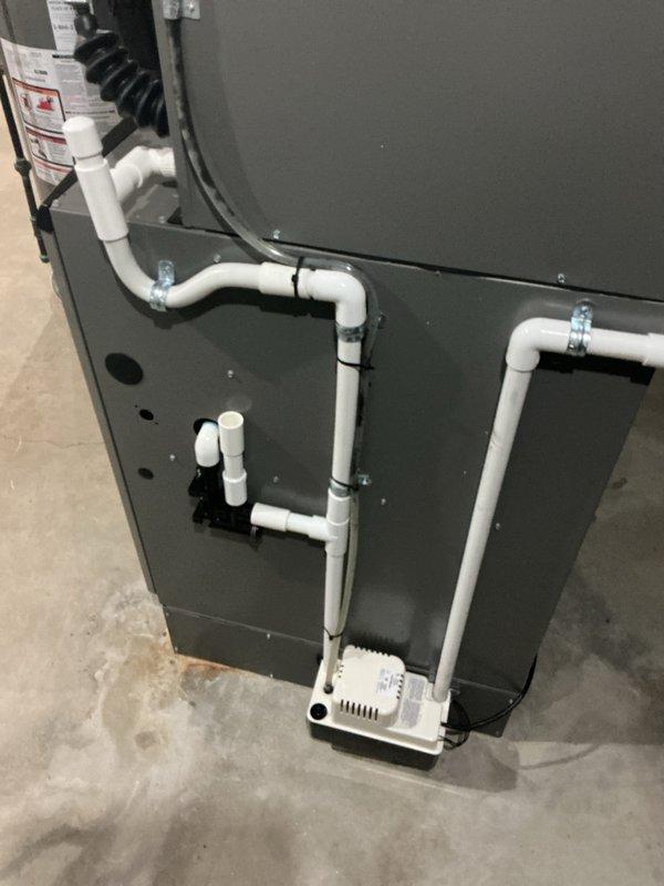 Completed air conditioning system startup for newly installed basement evaporator coil. Verified proper refrigerant line connections, condensate drainage system operation with PVC piping and condensate pump, and confirmed all electrical connections to control components. System tested and operating within manufacturer specifications with adequate airflow and drainage functioning correctly.