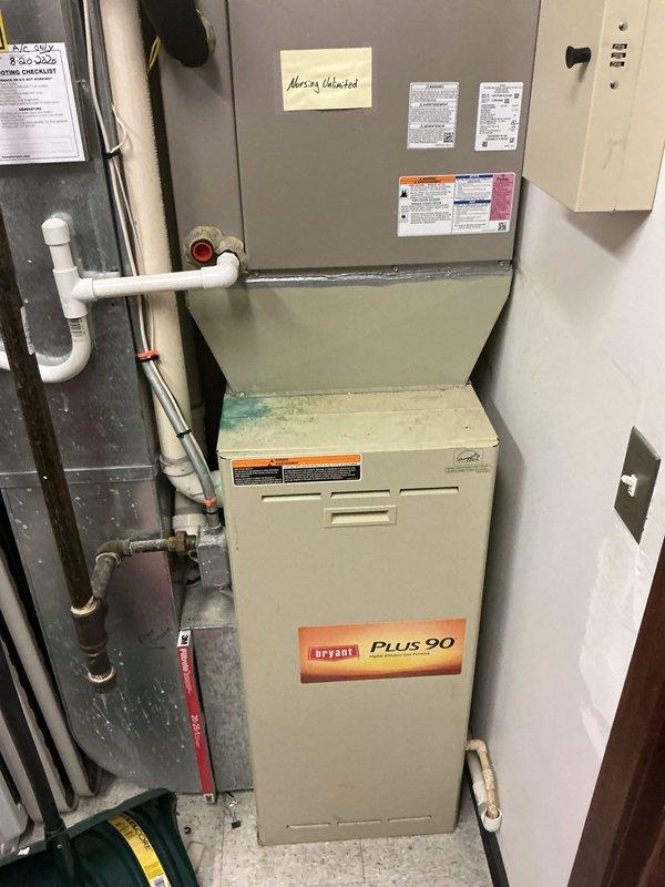 # HVAC Maintenance Agreement Service Completed

Performed scheduled commercial HVAC maintenance agreement service on Bryant Plus 90 furnace system with air handler/evaporator coil unit located on main floor. Conducted comprehensive inspection of all system components including furnace, air handler, condensate drainage system, and associated controls. Verified proper operation of equipment, documented system specifications from manufacturer labels (Model: CNPVP4821LA6AAA), and captured photographic documentation of equipment condition and warning labels for service records. System operational and in good working order upon completion of maintenance visit.