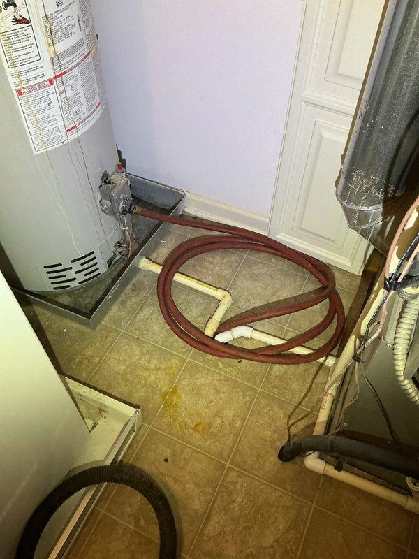 Completed mechanical reconnection of a 50-gallon natural gas water heater with natural draft venting in utility closet. Reconnected all plumbing connections, gas supply line, and verified proper venting configuration per manufacturer specifications and local code requirements.